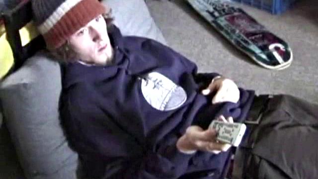 Adam relaxes on the floor watching porn video, strokes cock, plays with butthole, and blasts cum load onto skateboard