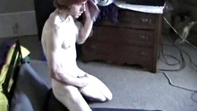 Adam relaxes on the floor watching porn video, strokes cock, plays with butthole, and blasts cum load onto skateboard