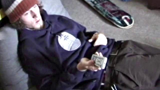 Adam relaxes on the floor watching porn video, strokes cock, plays with butthole, and blasts cum load onto skateboard