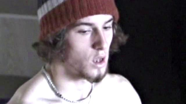 Adam relaxes on the floor watching porn video, strokes cock, plays with butthole, and blasts cum load onto skateboard