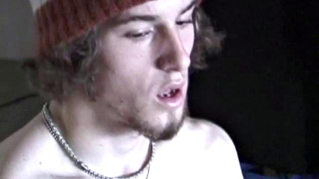 Adam relaxes on the floor watching porn video, strokes cock, plays with butthole, and blasts cum load onto skateboard