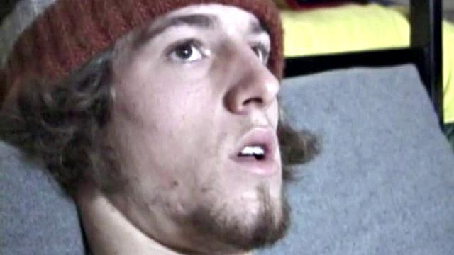 Adam relaxes on the floor watching porn video, strokes cock, plays with butthole, and blasts cum load onto skateboard