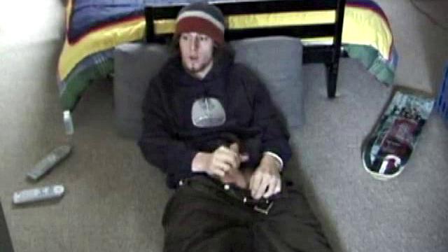Adam relaxes on the floor watching porn video, strokes cock, plays with butthole, and blasts cum load onto skateboard