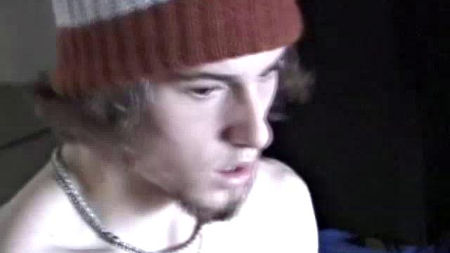 Adam relaxes on the floor watching porn video, strokes cock, plays with butthole, and blasts cum load onto skateboard