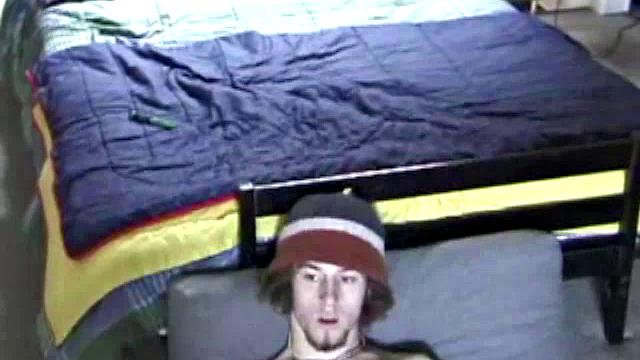 Adam relaxes on the floor watching porn video, strokes cock, plays with butthole, and blasts cum load onto skateboard