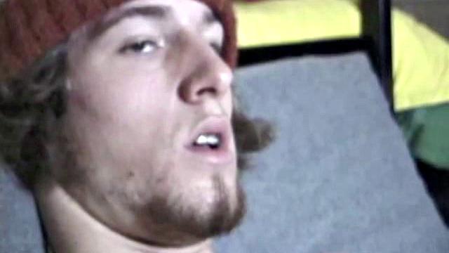 Adam relaxes on the floor watching porn video, strokes cock, plays with butthole, and blasts cum load onto skateboard