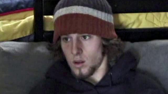 Adam relaxes on the floor watching porn video, strokes cock, plays with butthole, and blasts cum load onto skateboard