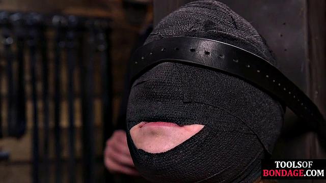 Masked BDSM babe tied up by master in his sex room