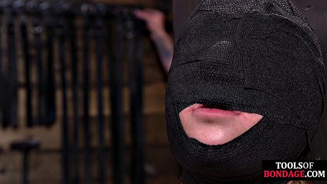 Masked BDSM babe tied up by master in his sex room