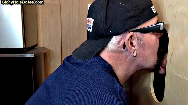 Senior gloryhole DILF blows BF's dick through hole