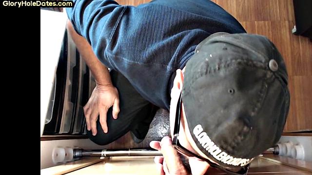 Senior gloryhole DILF blows BF's dick through hole