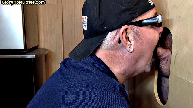 Senior gloryhole DILF blows BF's dick through hole