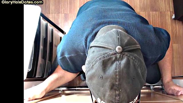 Senior gloryhole DILF blows BF's dick through hole