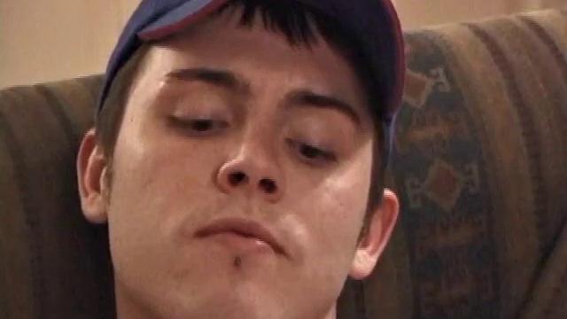 Christian Dane strips down to his underwear. When they are eventually removed we see this skinny little boy has a great big dick. He moves from sofa to the bed, all the while fingering his ass and balls while steadily stroking.