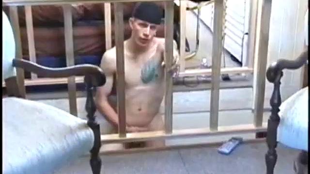 Dressed in baggy shorts and a baseball cap, popular Shane stands halfway up the stairs, watching his porno and talking about making the wall the target for his cum shot.