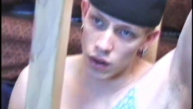 Dressed in baggy shorts and a baseball cap, popular Shane stands halfway up the stairs, watching his porno and talking about making the wall the target for his cum shot.