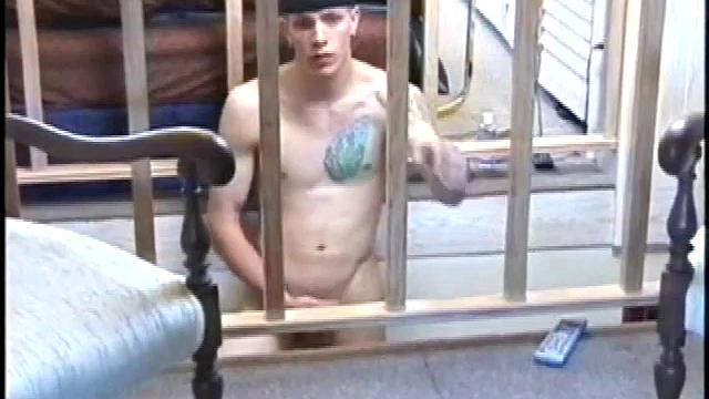 Dressed in baggy shorts and a baseball cap, popular Shane stands halfway up the stairs, watching his porno and talking about making the wall the target for his cum shot.