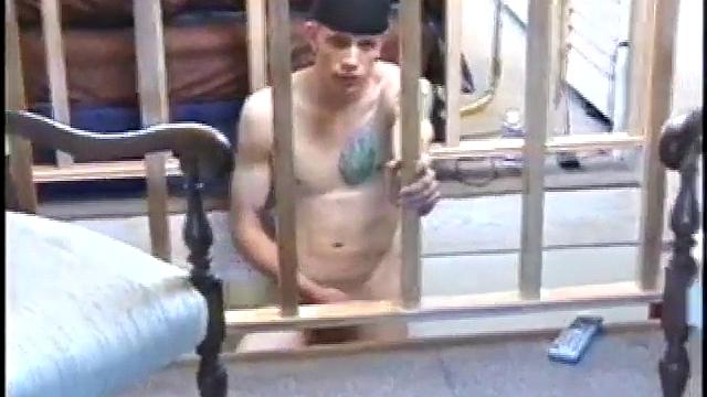 Dressed in baggy shorts and a baseball cap, popular Shane stands halfway up the stairs, watching his porno and talking about making the wall the target for his cum shot.