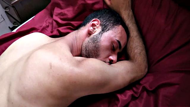 Piero plays with his package on the bed