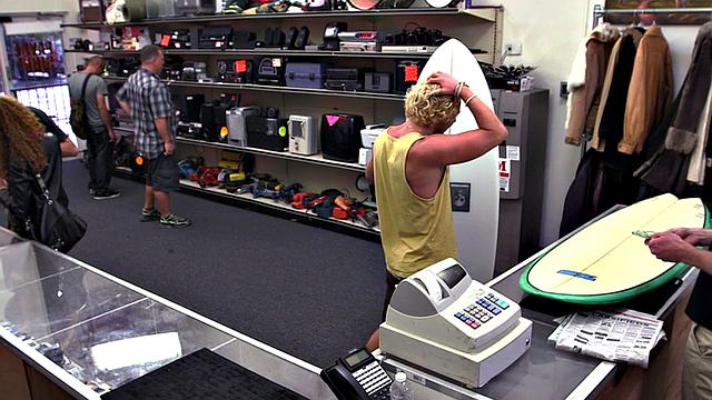 Watch these two hot blondes take turns getting their assholes drilled in the office of the store