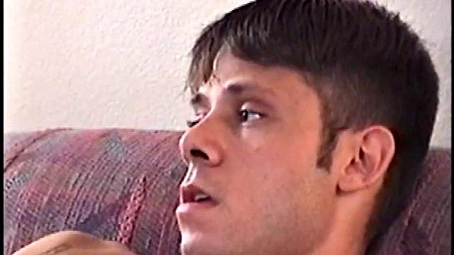 This tattooed misfit quickly strips down, lubes up, and strokes on the sofa.