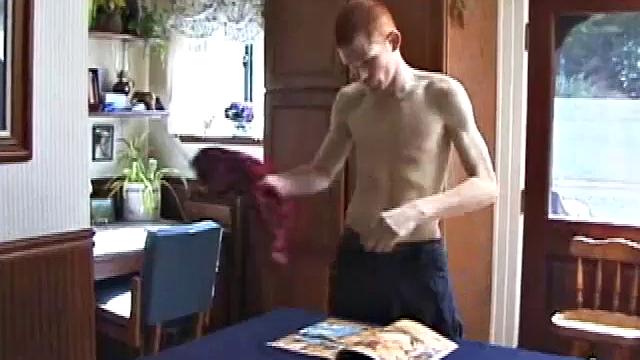 Always horny red haired skater Tristian covers the kitchen table with a large blue towel, stretches out a tape measure the length of the table, pulls out a porn magazine, tugs off his shirt, and gts down to business.