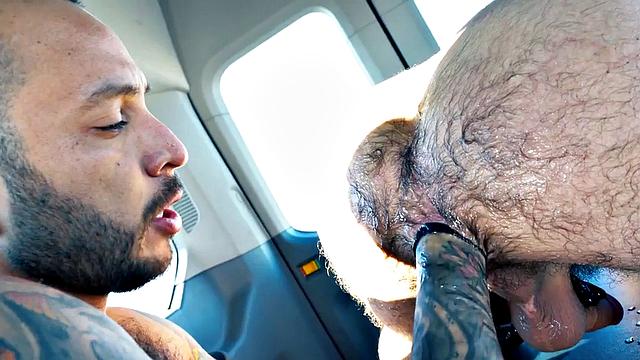 Muscular hunk gets his ass lubed up and fisted in car ride