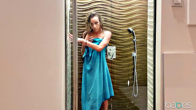 Curly-haired babe with tattoos enjoys solo play in the shower with dildo