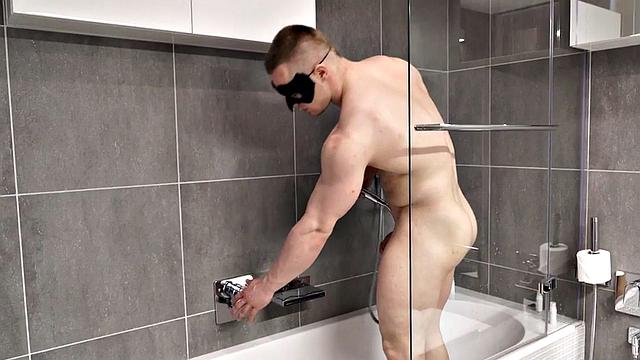 Muscled stud with mask masturbates and cums in solo action