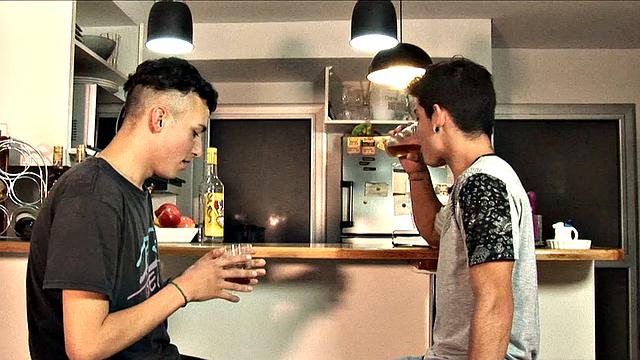 While enjoying their drinks, these two slim and young Latinos are quick to start making out, and in no time Adrian has his lips wrapped around Dylan's big uncut cock.