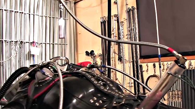 BDSM domina in leather pumping sub's pathetic cock