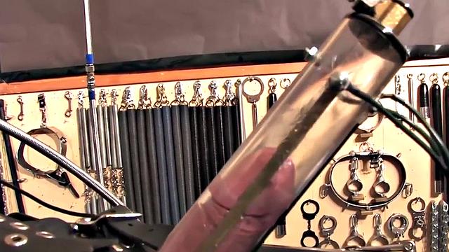 BDSM domina in leather pumping sub's pathetic cock