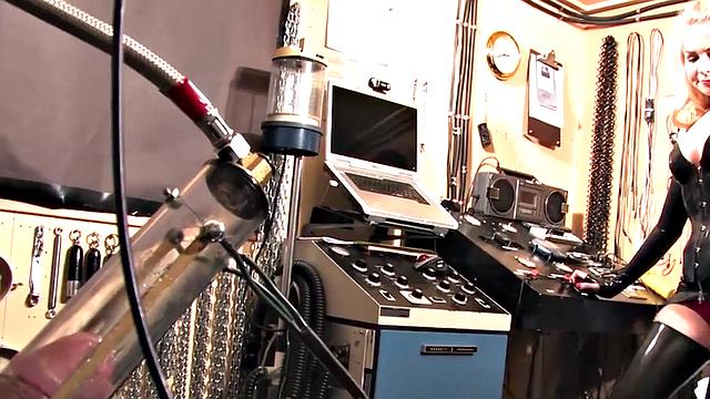 BDSM domina in leather pumping sub's pathetic cock