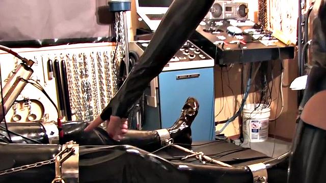 BDSM domina in leather pumping sub's pathetic cock