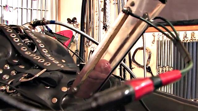 BDSM domina in leather pumping sub's pathetic cock