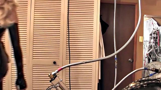 BDSM domina in leather pumping sub's pathetic cock