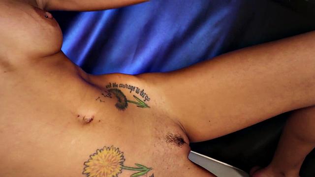 A tattooed natural-titted brunette give a customer a hard handjob with her small tits and pierced pussy