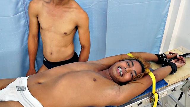 We strapped Hunter down on our tickling rack and released our sadistic ticklers Argie and Vahn on him. First was Argie.