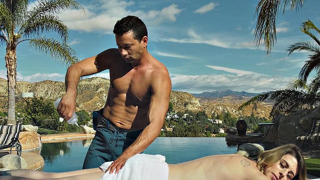 Tattooed shemale oils up and fucks masseur in public pool for a good handjob