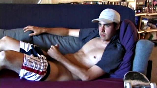 This 21 year old skater boy leans back on a sofa and rubs himself through his jeans. Getting harder, Mark shows off his nice boner while staring into the camera.