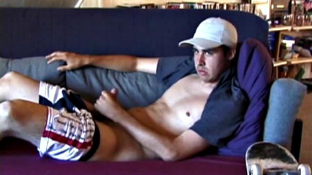 This 21 year old skater boy leans back on a sofa and rubs himself through his jeans. Getting harder, Mark shows off his nice boner while staring into the camera.