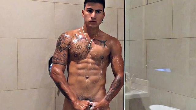 Our featured solo boy of the week is Erick, a muscular and inked young Latino who invites us to watch as he jerks off in the shower.