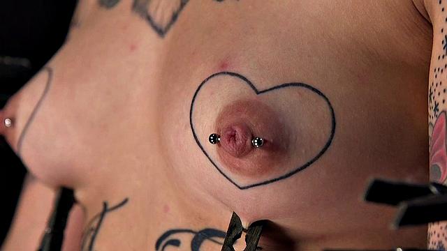 BDSM inked and pierced babe gets nipples and pussy clamps