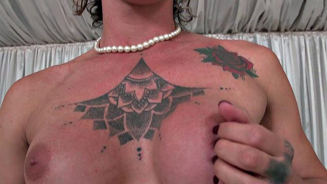 A tattooed babe smoke while tugging on a big cock in solo play