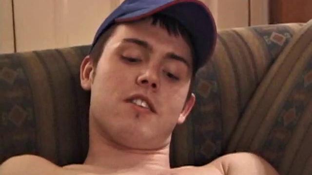 Christian Dane strips down to his underwear. When they are eventually removed we see this skinny little boy has a great big dick. He moves from sofa to the bed, all the while fingering his ass and balls while steadily stroking.