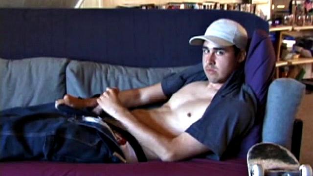 This 21 year old skater boy reclines on a sofa and rubs himself through his jeans. Getting harder, Mark shows off his nice boner while staring into the camera.