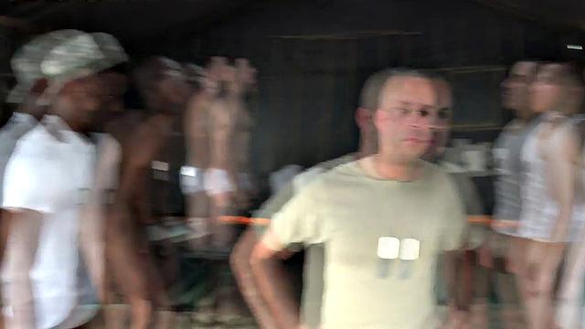 Watch these soldiers go wild in a wild outdoor interracial orgy with a submissive wearing glasses and a black tank top
