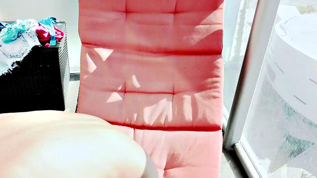 Teenage Balcony Flasher shows off her perky tits and tanlines on her ass.