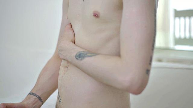 Inked twink solo jerking before cumming on stomach