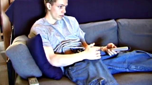 Young Shane relaxes on the sofa while watching a porn video and gets totally into himself. He delivers a nice long stroke show, before shooting onto his t-shirt.